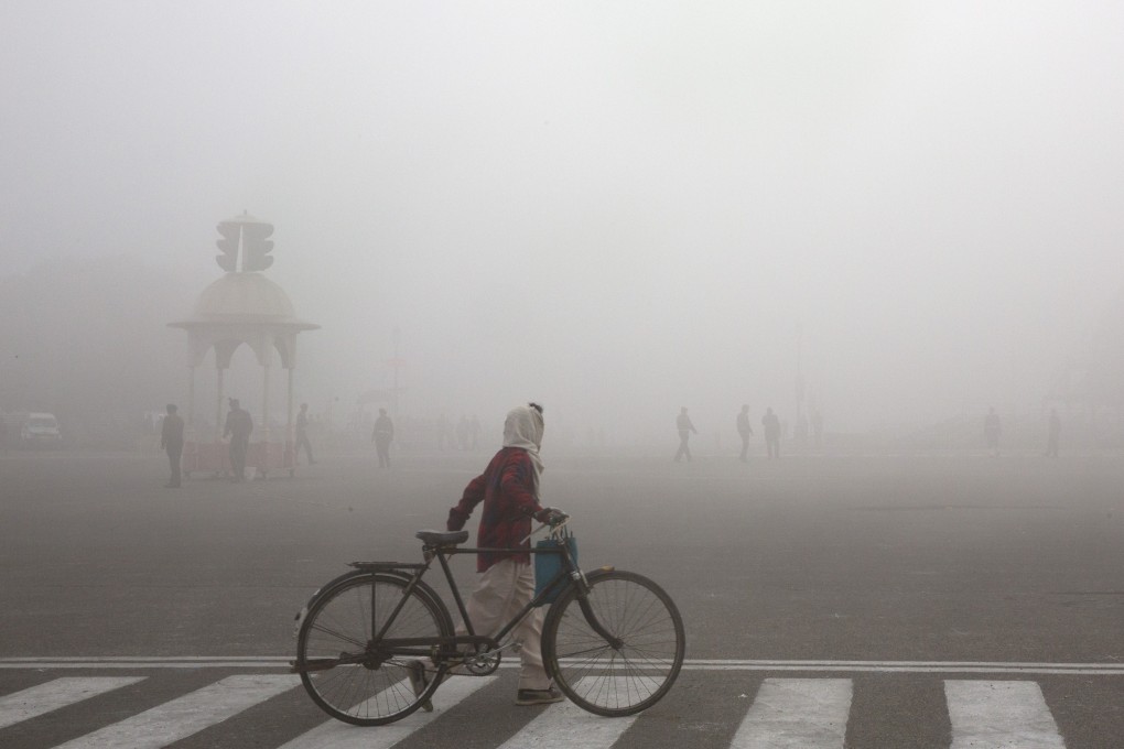 A cyclist amid morning smog in New Delhi, India. Photo: AP