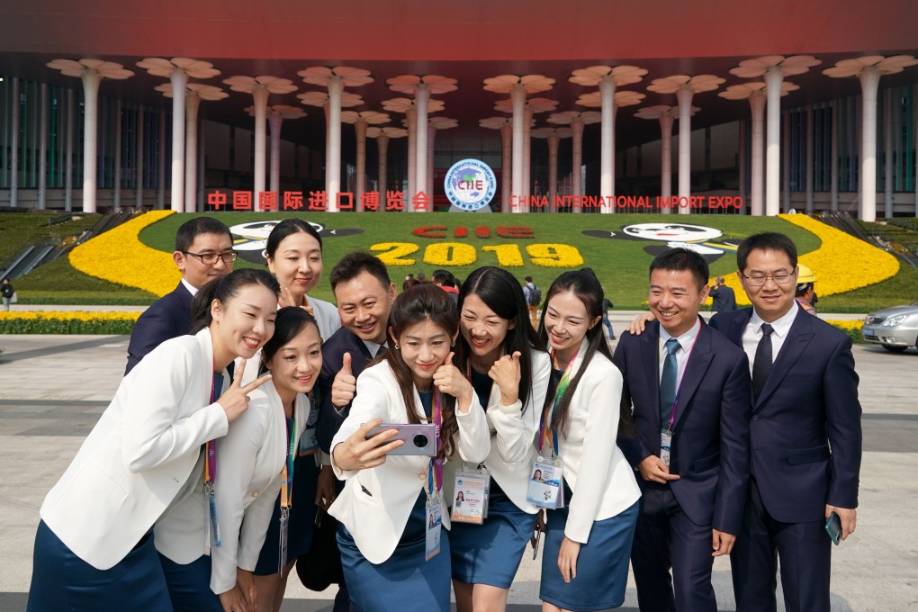 Staff members pose at the venue for the second China International Import Expo in Shanghai on Monday. The event runs from November 5 to 10. Photo: Xinhua