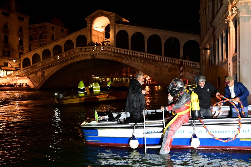 A scuba diver of the Venice Gondolieri association dives in the Canal Grande on Sunday. Photo: AFP