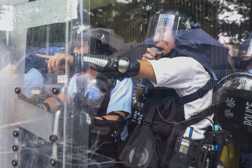 Riot police officers warn protesters to stop as the crowd smashes windows of the Legislative Council Complex in Admiralty during a demonstration against the now-withdrawn extradition bill on July 1, the 22nd anniversary of Hong Kong’s return to China. Photo: K.Y. Cheng