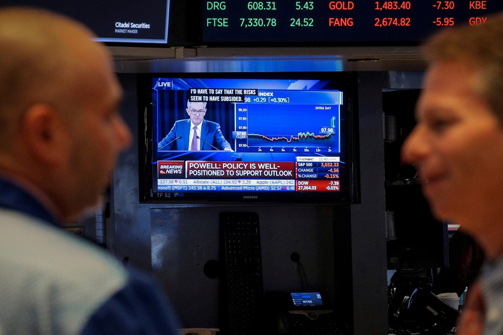 Traders work at the New York Stock Exchange on October 30 as a screen shows Federal Reserve chairman Jerome Powell’s news conference after the announcement of a third rate cut. Photo: Reuters