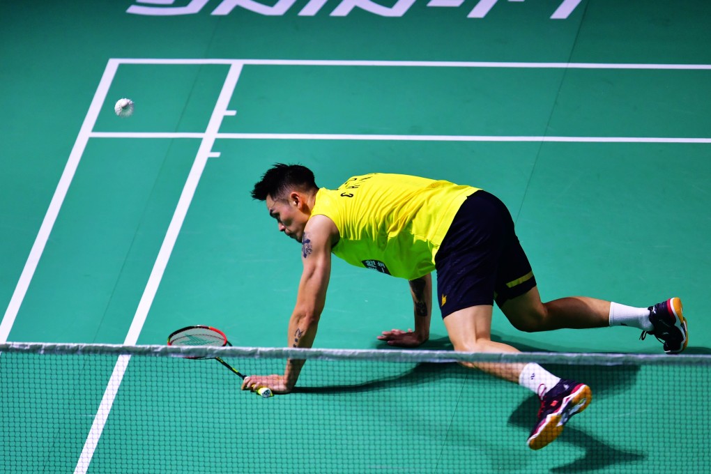 Down and out ... China’s Lin Dan slips during his first-round defeat at the China Open on Wednesday. Photos: Xinhua