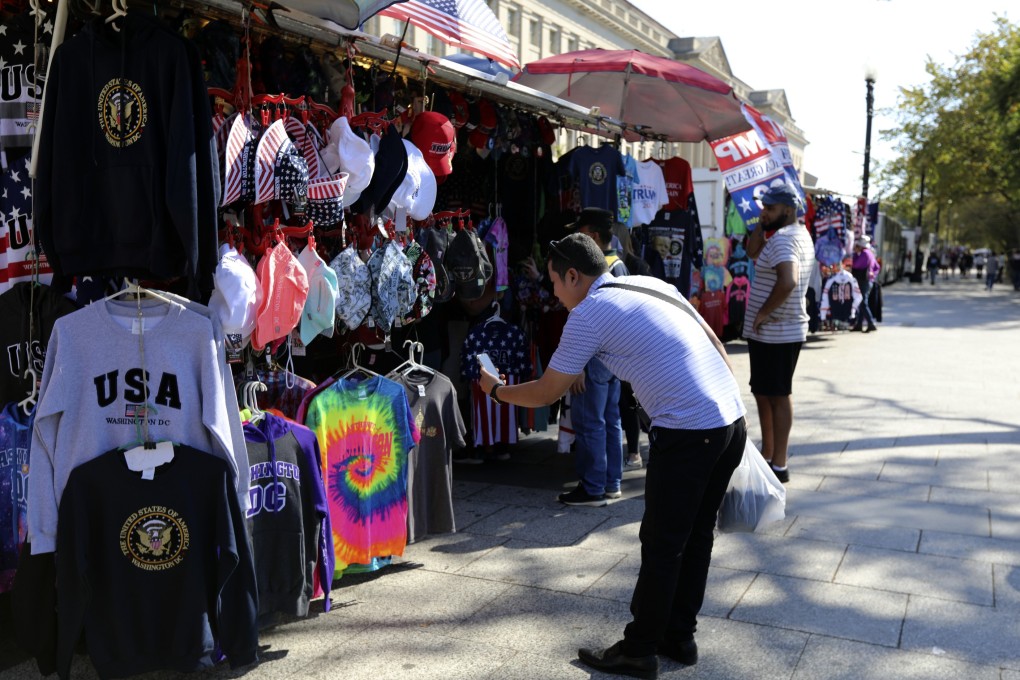 A Chinese tourist takes pictures at a tourism kiosk in Washington in October 2019. Photo: AP