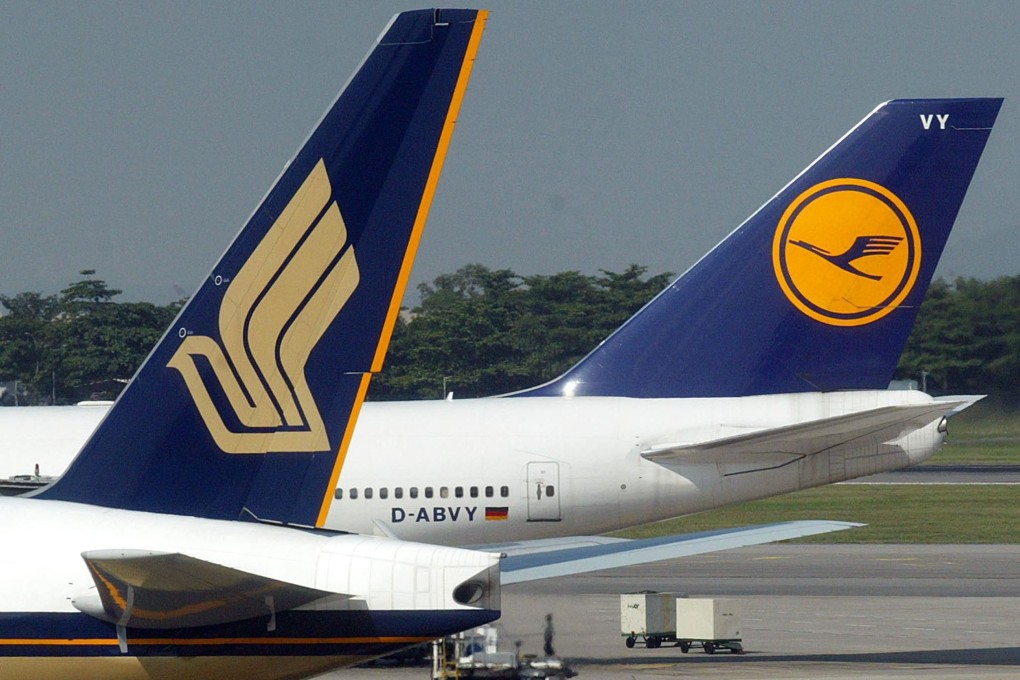 Singapore Airlines (left) on Tuesday reported stable net income in the first six months of the financial year with profits up 4.9 per cent to S$205.6 million (US$151.3 million). Photo: AFP