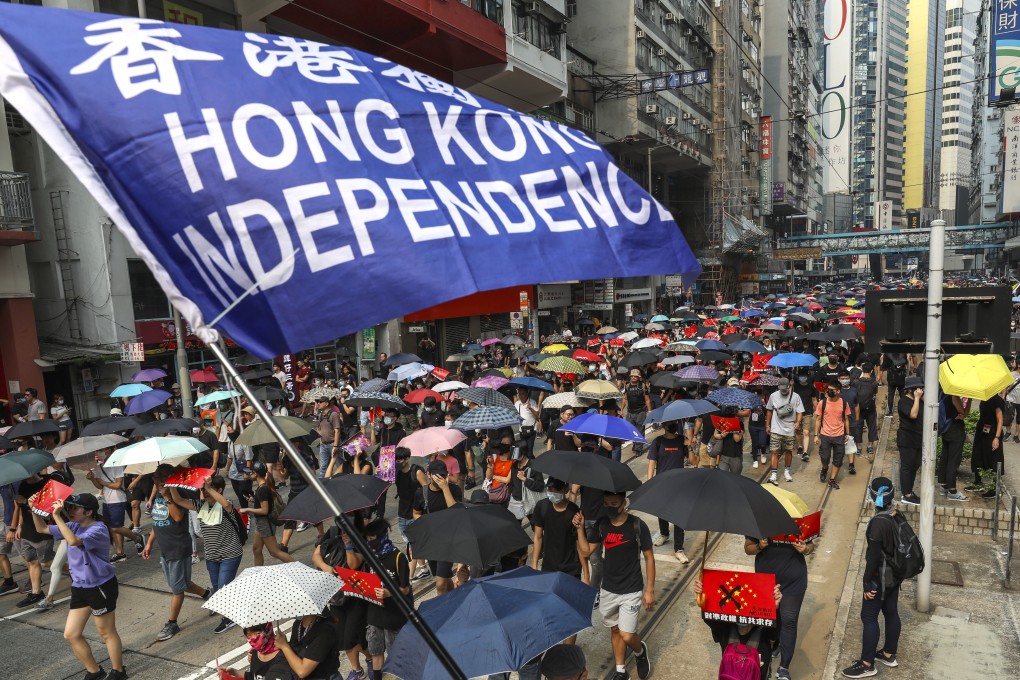 A protester holds up a “Hong Kong independence” flag during a march against the government’s extradition bill from Causeway Bay to Admiralty on September 29. While not all protesters support Hong Kong independence, there is a widespread feeling that Hong Kong has a unique identity that is under threat and worth fighting for. Photo: Robert Ng