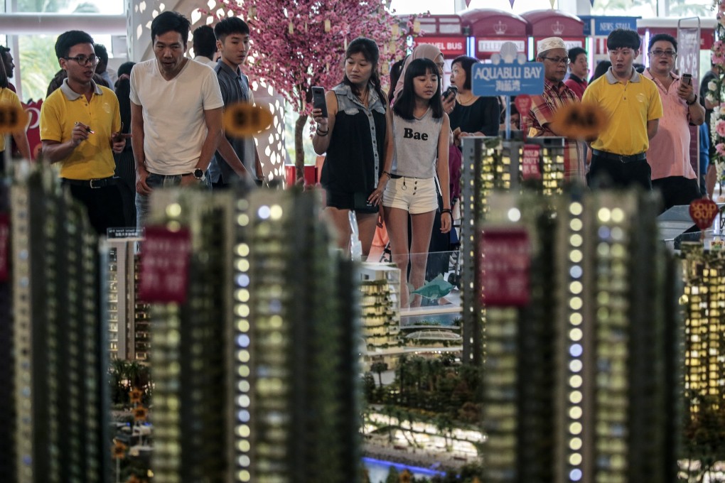 Foreign buyers view a scale model of a development in Johor, Malaysia. Photo: EPA
