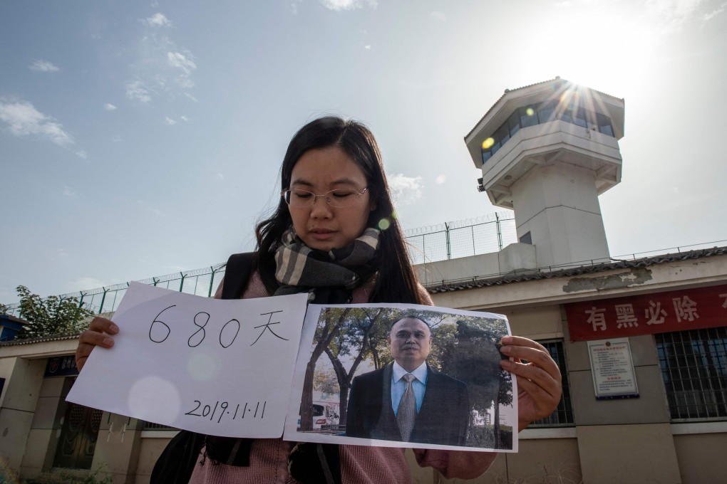 Xu Yan outside Xuzhou City Detention Centre, displaying the date of her husband Yu Wensheng’s birthday, which will mark 680 days in detention. Photo: AFP
