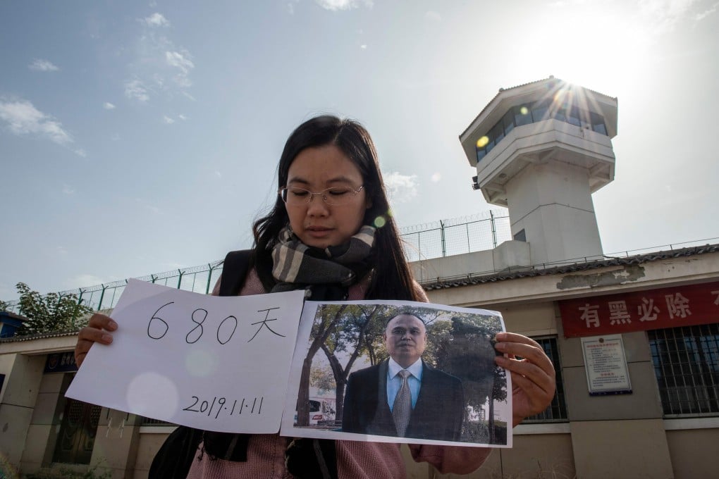 Xu Yan outside Xuzhou City Detention Centre, displaying the date of her husband Yu Wensheng’s birthday, which will mark 680 days in detention. Photo: AFP