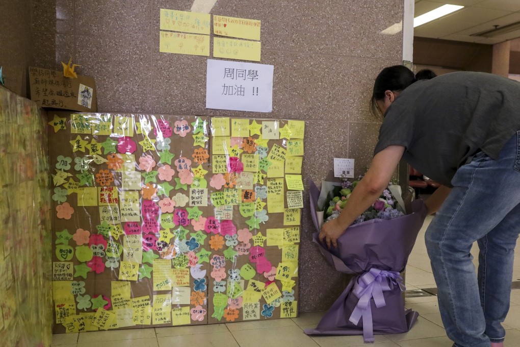 Flower bouquets, paper cranes and Post-it messages from people wishing Chow Tsz-lok a speedy recovery were placed in the lobby outside the intensive care unit of Queen Elizabeth Hospital on Thursday. Photo: Nora Tam