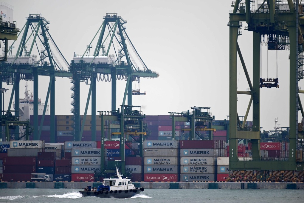 A boat sails past a container port terminal in Singapore. Photo: AFP