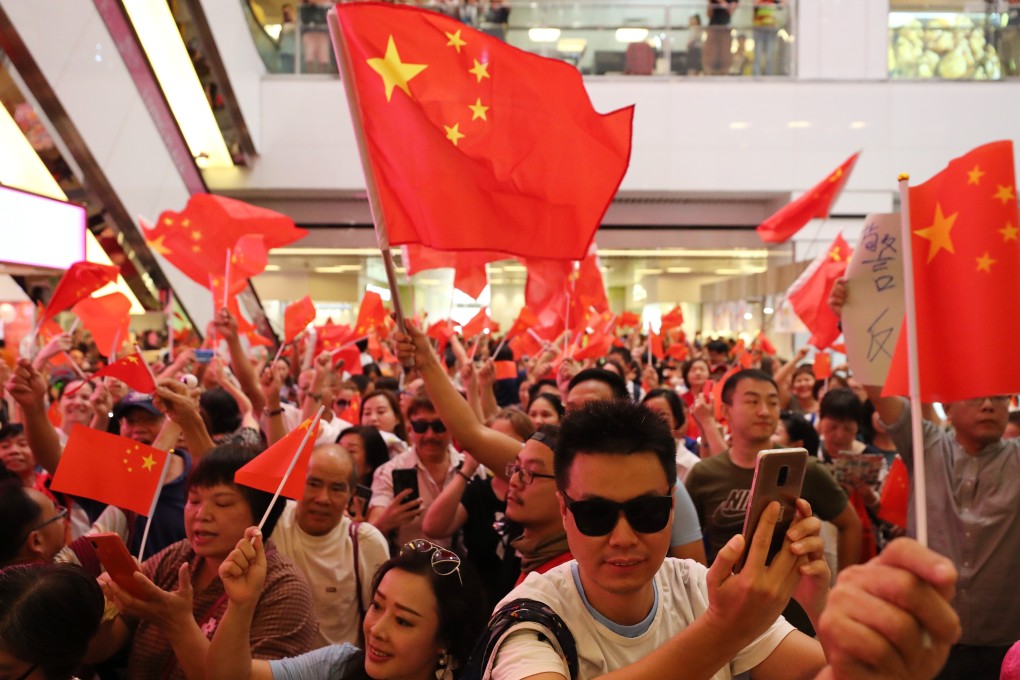 Pro-Beijing supporters wave Chinese flags at Amoy Plaza in Kowloon Bay on September 14. Photo: Sam Tsang