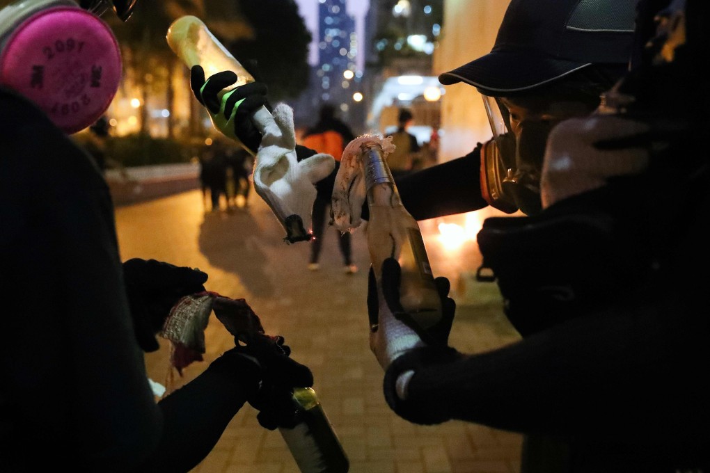 Protesters prepare petrol bombs in the Sham Shui Po district of Hong Kong on October 1, amid violent demonstrations and clashes with police across the city. Photo: AFP