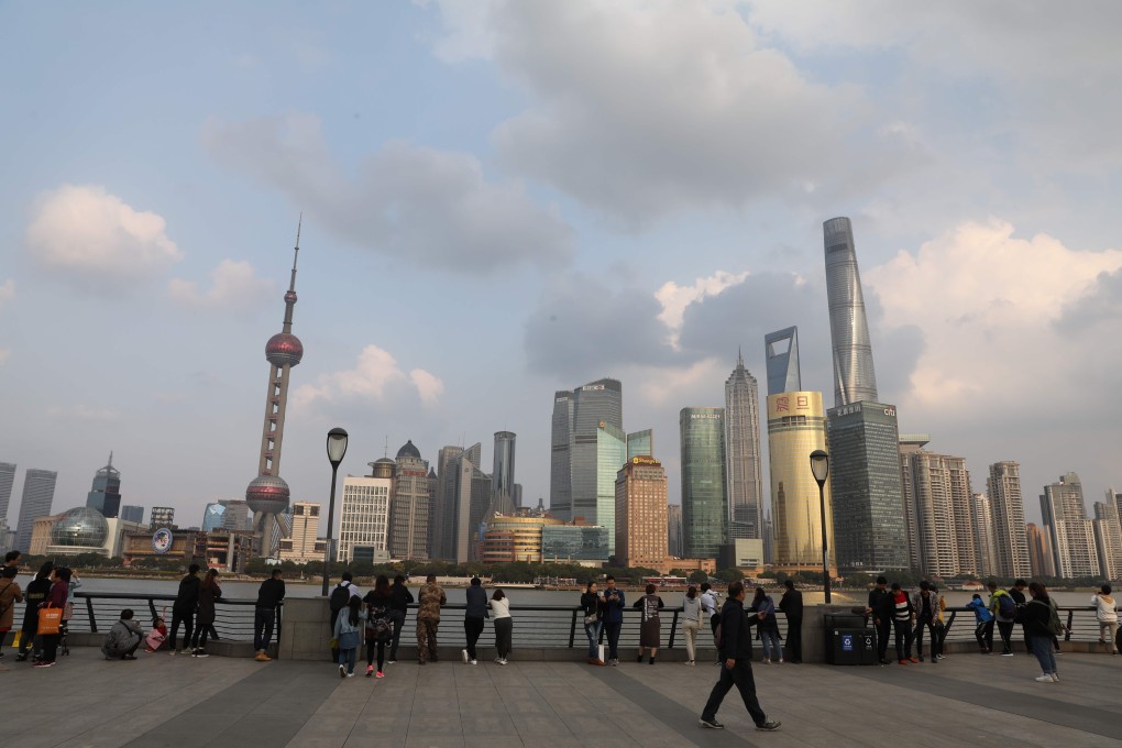 People take in the view of the skyline of Shanghai’s Pudong financial district. China’s increasing integration into the global financial system should lead its asset market returns to become more correlated with global markets – something that is already happening. Photo: AFP
