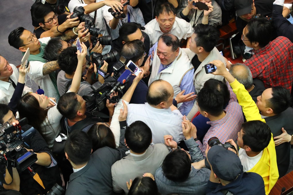 Legislator Abraham Razack is surrounded by other lawmakers on May 11. Photo: Edmond So