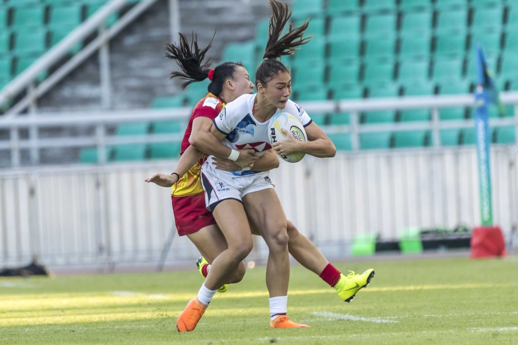 Florence Symonds is on the end of a thumping tackle in the Olympic qualifier final against China. Photos: HKRU