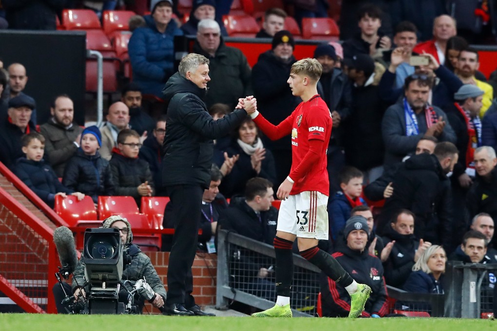 Manchester United's Brandon Williams (right) shakes hands with manager Ole Gunnar Solskjaer as he is substituted during the English Premier League match against Brighton and Hove Albion. Photo: PA