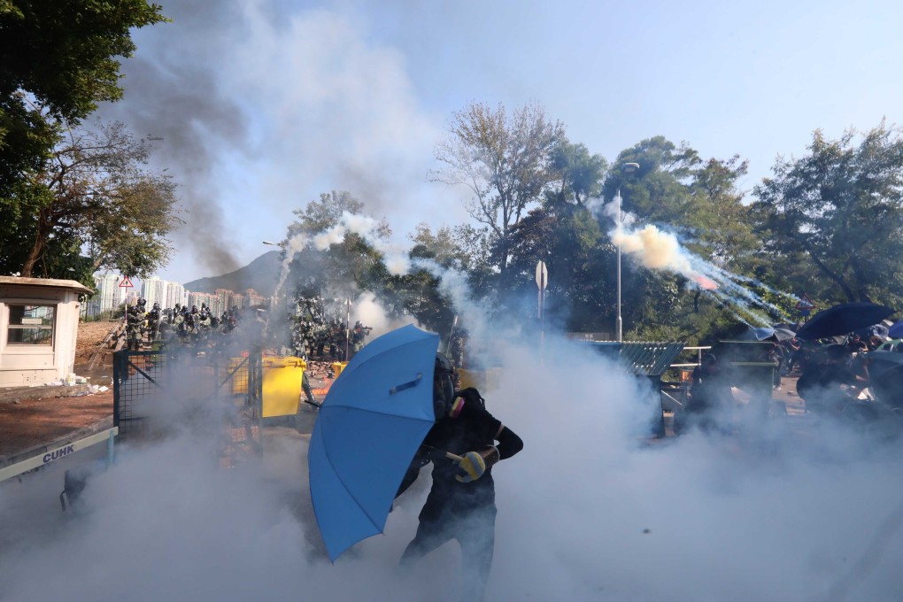 Riot police fire tear gas in and around the Chinese University of Hong Kong campus on Monday. Photo: Felix Wong