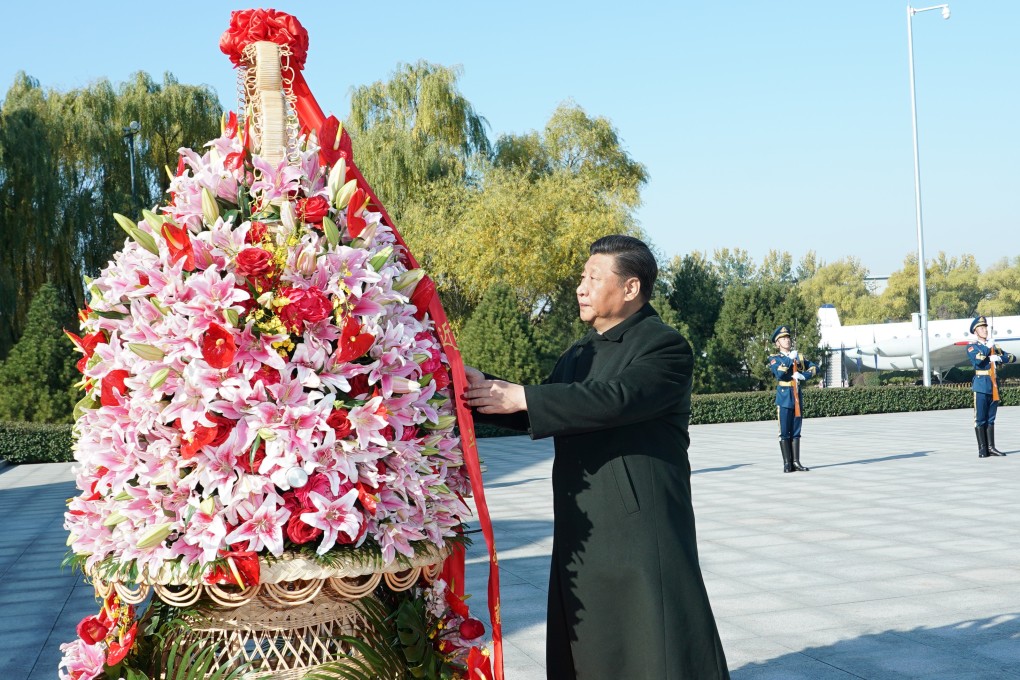 President Xi Jinping presents a flower basket commemorating deceased PLA Air Force officers in Beijing on Friday. Photo: Xinhua