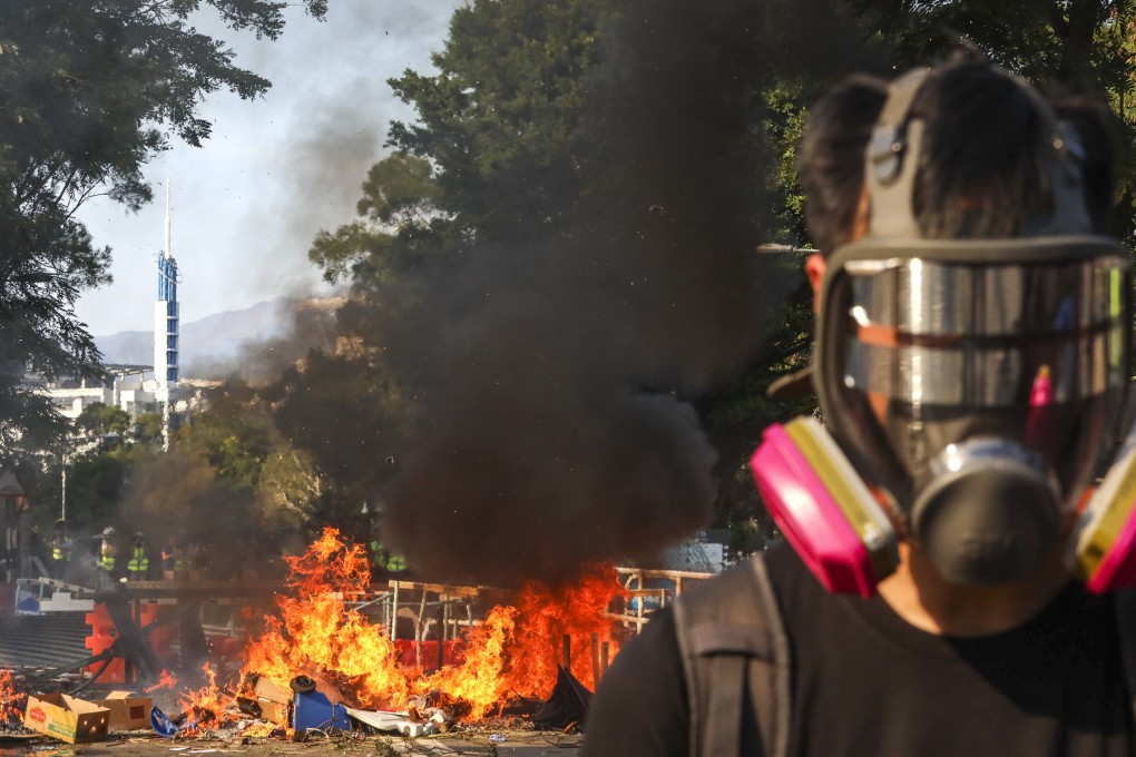 Anti-government protesters set fire to roadblocks disrupting traffic outside the Chinese University of Hong Kong in Sha Tin early on Monday. Photo: Felix Wong