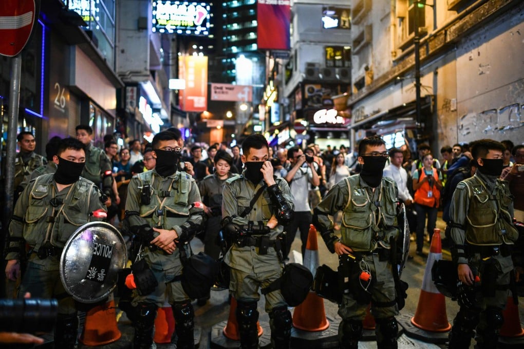 A line of police officers in Lan Kwai Fong, Hong Kong’s entertainment district, during Halloween night on October 31. Photo: AFP