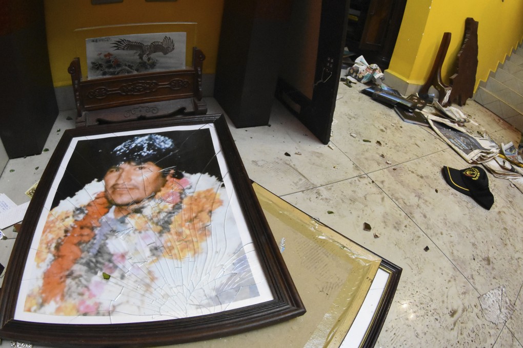 A broken portrait of former Bolivia president Evo Morales on the floor of his private home in Cochabamba, Bolivia, after hooded opponents broke into the residence. Photo; AP