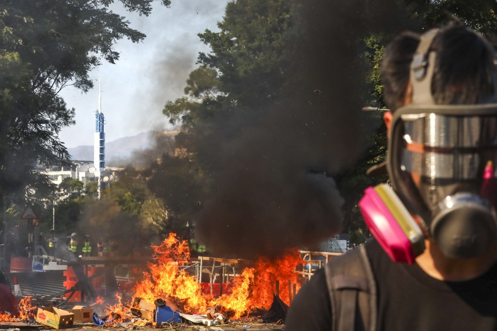 Anti-government protesters set fire to roadblocks disrupting traffic in Hong Kong on Monday. Photo: Felix Wong