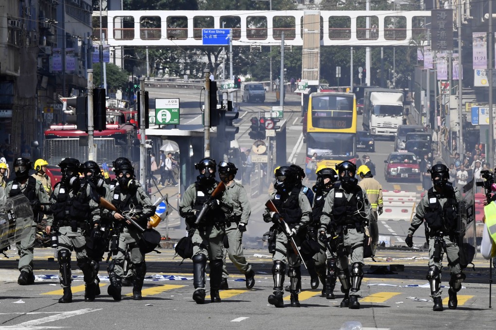 Police in Hong Kong clearing out demonstrators after injuring a protester with a live round on November 11. Pushing the city into chaos would allow Beijing to send in troops and take control, but would mark the beginning of the end. Photo: Kyodo