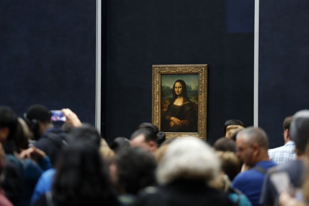 Tourists wait to see Leonardo da Vinci's painting Mona Lisa at the Louvre in Paris. An art critic has suggested the painting is a security hazard and “not even a satisfying bucket-list item”, and proposed it be moved, drawing a big response. Photo: AP