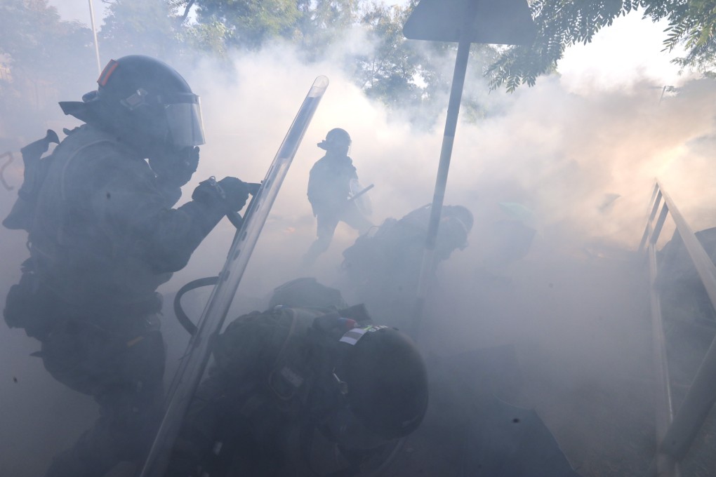 Riot police fire tear gas and make arrests as anti-government protesters set up roadblocks outside Chinese University of Hong Kong in Sha Tin early on Monday. Photo: Felix Wong
