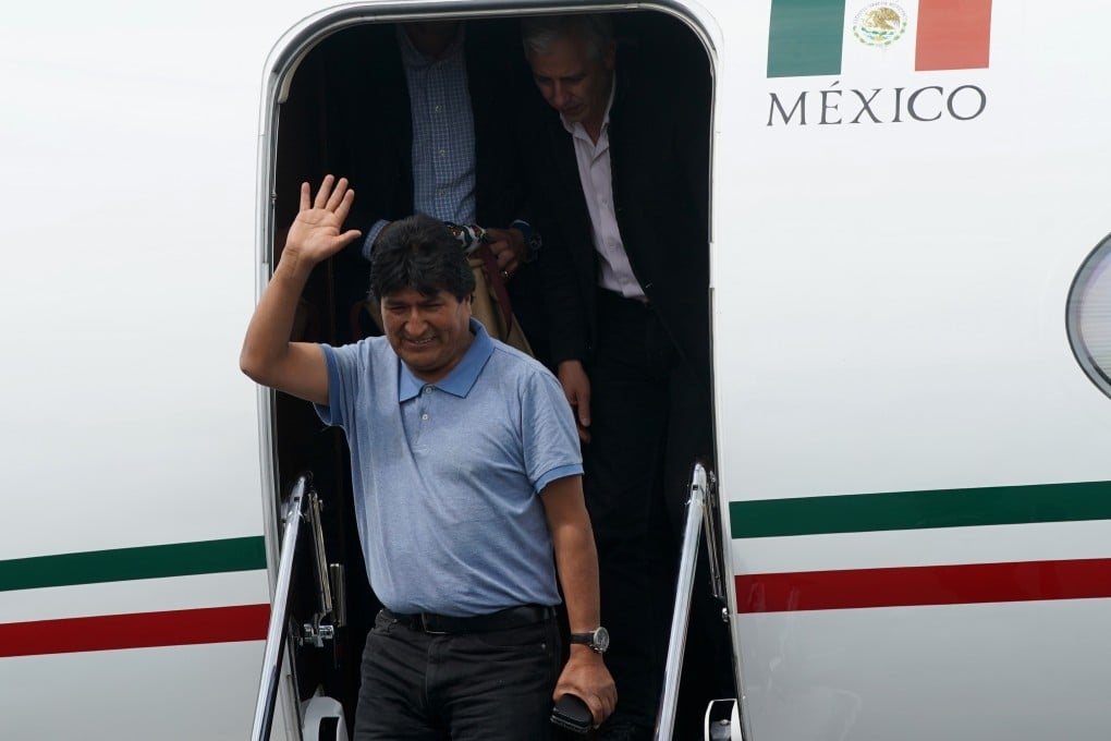 Evo Morales waves upon his arrival at the airport in Mexico City on Tuesday. Photo: Xinhua