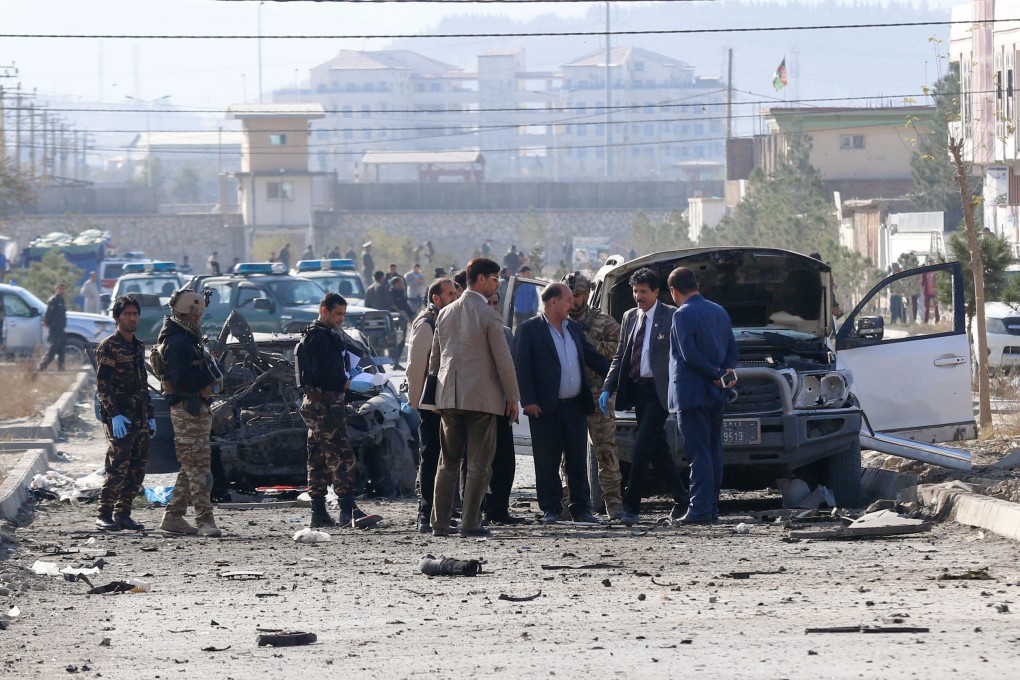 Security personnel and investigators gather at the site of a suicide attack in Kabul on November 13. Photo: AFP
