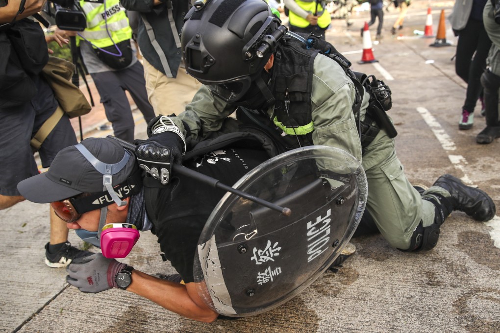 A police officer restrains a protester at Chinese University in Sha Tin on November 12. Photo: Winson Wong