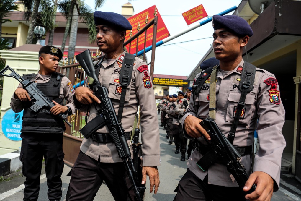 Police officers stand guard at the scene of a suicide bombing in Medan city. Photo: EPA-EFE