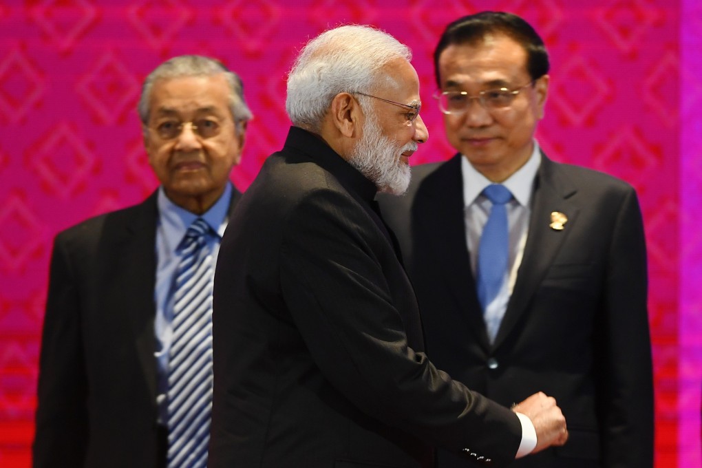 India’s Prime Minister Narendra Modi walks past Malaysia’s Prime Minister Mahathir Mohamad (left) and China’s Premier Li Keqiang (right) during the 14th East Asia Summit in Bangkok on November 4, on the sidelines of the 35th Asean Summit. Photo: AFP