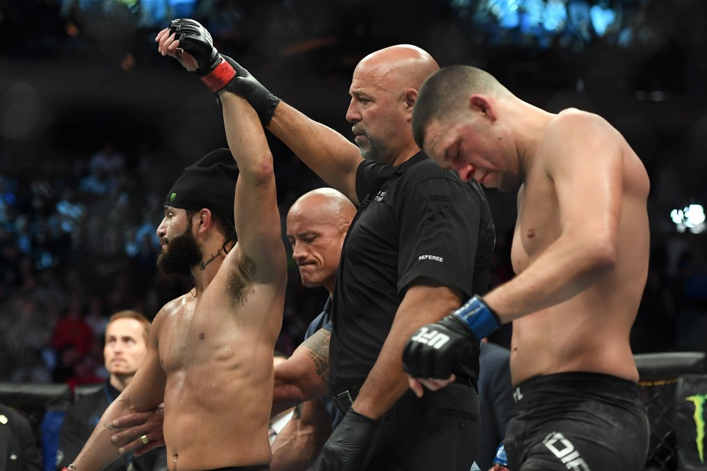 Nate Diaz looks dejected as Dwayne ‘The Rock’ Johnson raises Jorge Masvidal’s arm at UFC 244. Photo: USA TODAY Sports
