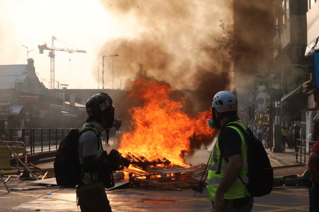 A fire set by protesters burns near Yau Ma Tei MTR station at Waterloo Road on October 20. Photo: Felix Wong