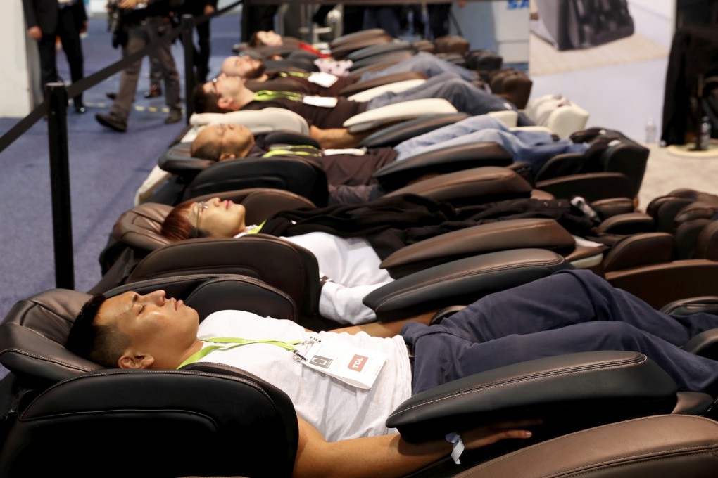 People try out massages chair during the 2018 CES in Las Vegas, Nevada. Photo: Reuters