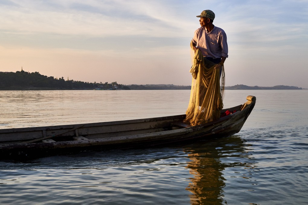 Dolphins and fishermen work together in Myanmar’s Irrawaddy River, where the marine mammals are under threat from overfishing. U Aung Thinn (above) has been practising this form of cooperative fishing since the age of 12.