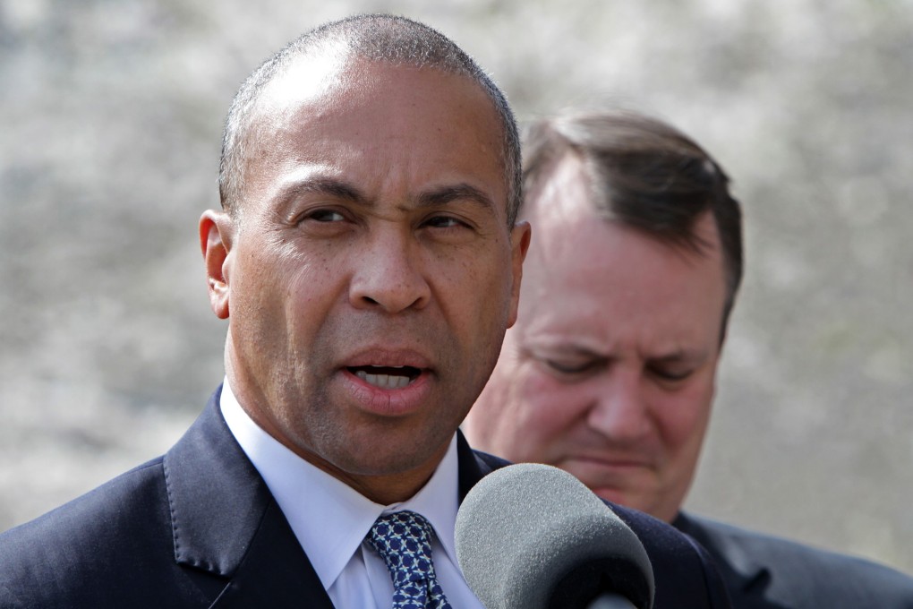 Then Governor Deval Patrick (left, with then Lieutenant Governor Tim Murray) speaks before a moment of silence for marathon bombing victims at the statehouse in Boston, Massachusetts, in April 2013. Photo: Boston Herald via TNS