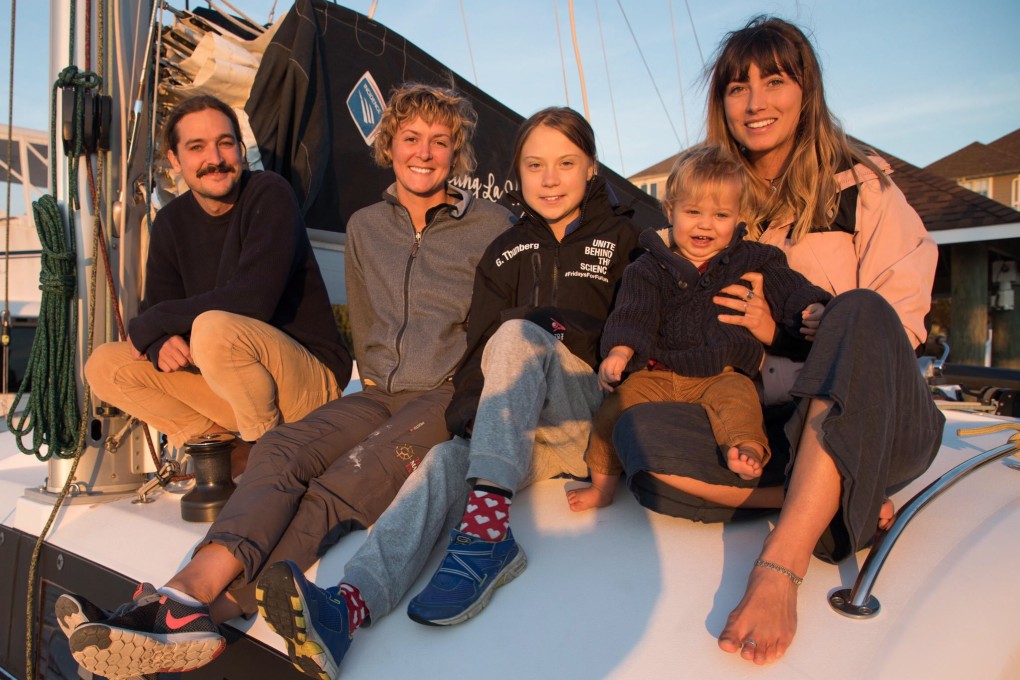Greta Thunberg with Australian couple Riley Whitelum (left) and Elayna Carausu (right, holding their child, Lenny) and English sailor Nikki Henderson (second left) on board the catamaran La Vagabonde in Virginia on Tuesday. Photo: EPA-EFE