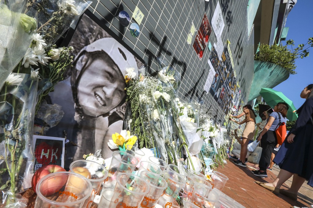 People lay flowers at the car park in Tseung Kwan O, Hong Kong, where protester Chow Tsz-lok was fatally injured. Photo: Felix Wong