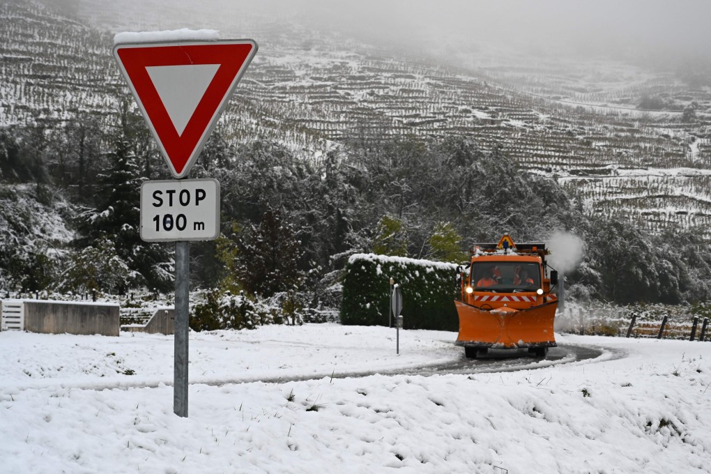A snowplough drives along a snow-covered road near Tournon-sur-Rhone on Friday. Photo: AFP