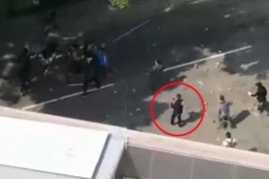 The 70-year-old man (circled) had been taking pictures when hit on the head by a brick, police say. Photo: Facebook