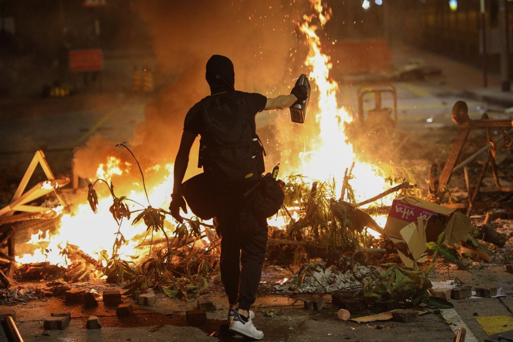 A protester burns a rubbish pile on a road during a protest at Chinese University on Wednesday. Photo: EPA-EFE