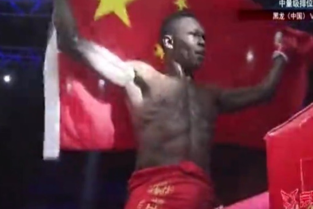 Israel Adesanya holds up the Chinese flag. Photo: Twitter