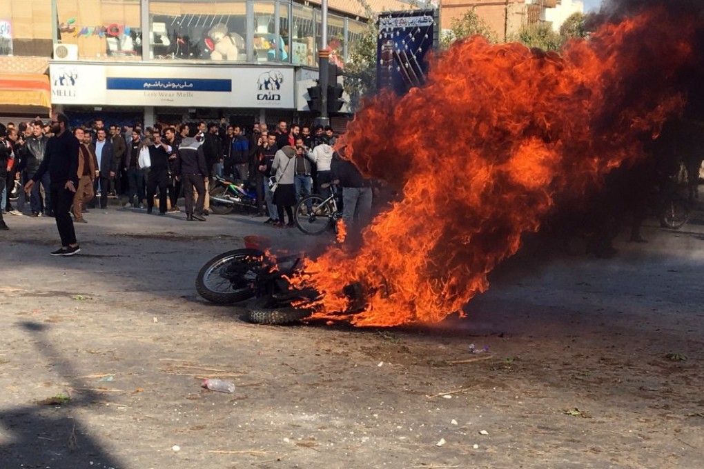 Iranian protesters clash in the streets following a fuel price increase of up to 50 per cent. Photo: EPA-EFE
