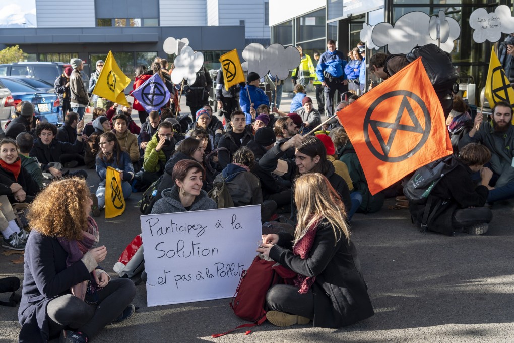 Extinction Rebellion climate change activists block an entrance to general aviation terminal at the Geneva Airport. Photo: EPA-EFE
