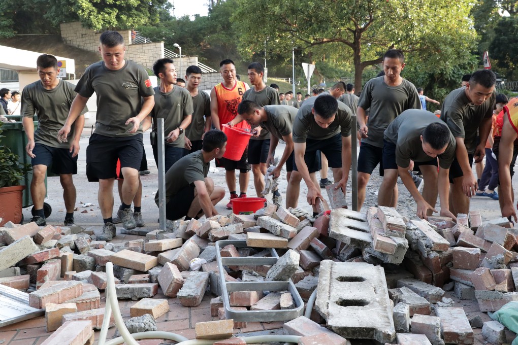 Soldiers from the People’s Liberation Army help clear roadblocks in Kowloon Tong near Baptist University. Photo: Edmond So