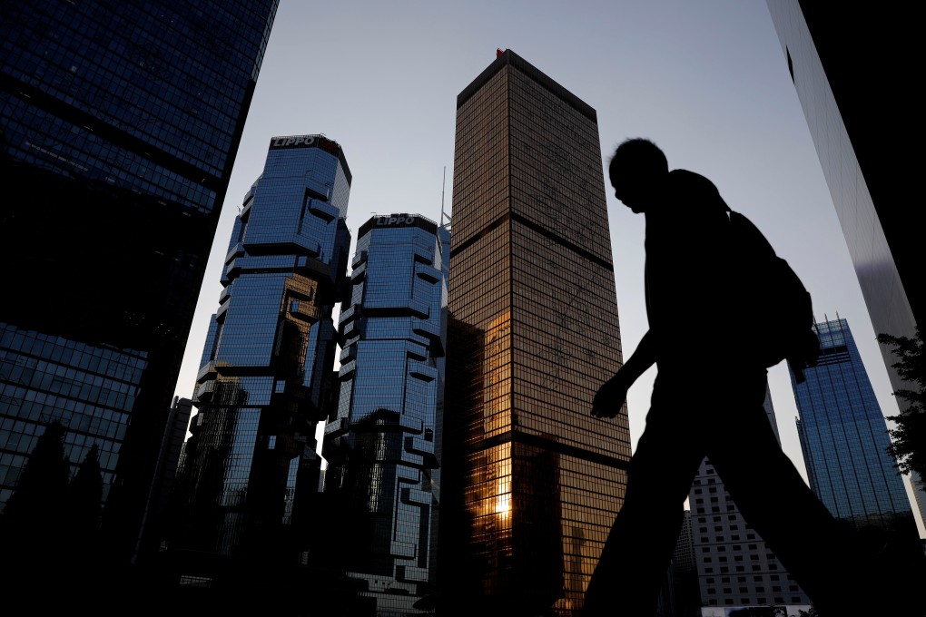 A man walks past buildings in Central, Hong Kong. A survey has found Hong Kong and Singapore are falling behind European countries in talent retention. Photo: Reuters