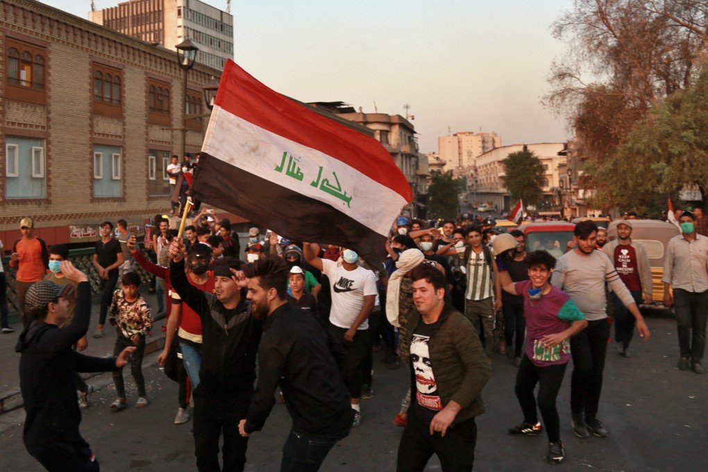 Protesters celebrate on the Ahrar Bridge, in Baghdad. Photo: AP Photo